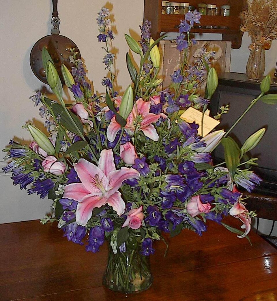 Arrangement of lilies and wildflowers